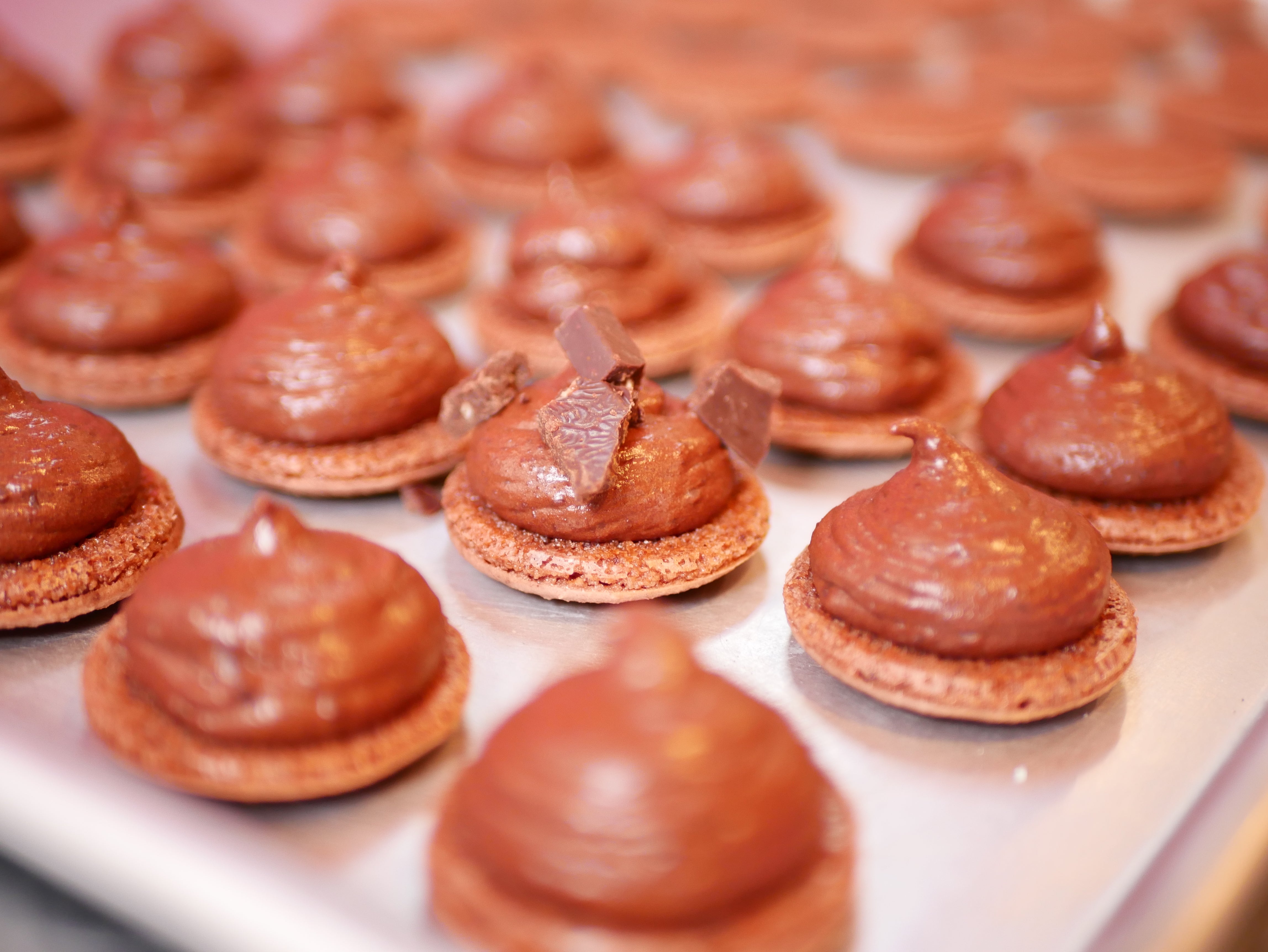 Sheet pan of dark chocolate macarons made with To'ak chocolate