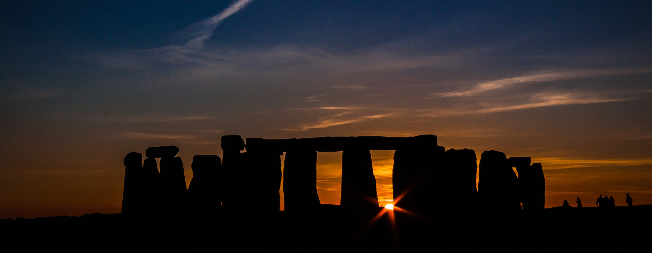 view of Stonehenge at sunset during the Summer Solstice